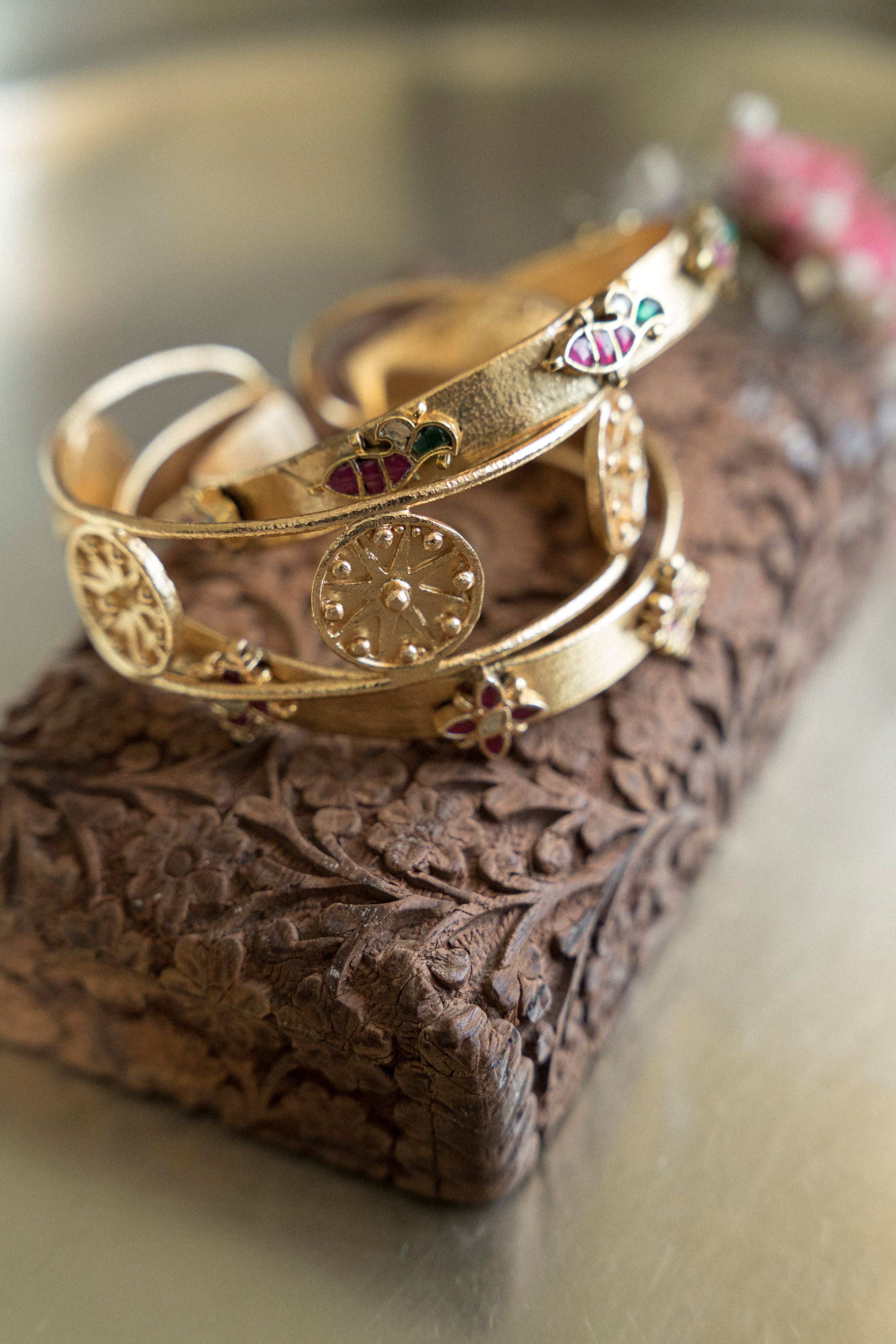 Handcrafted 18k gold-plated brass bangle stack featuring intricate floral and fish motifs