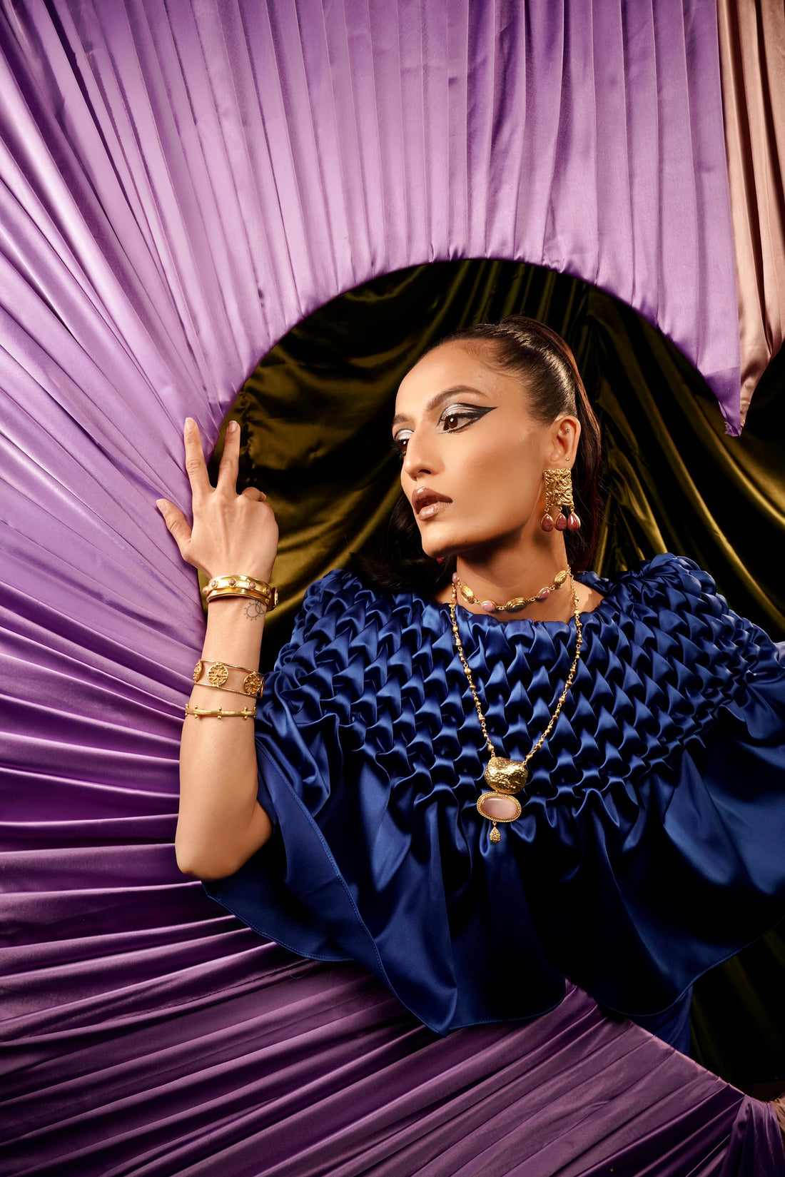 Model wearing 18k gold-plated stacked bangles set with rose quartz stone