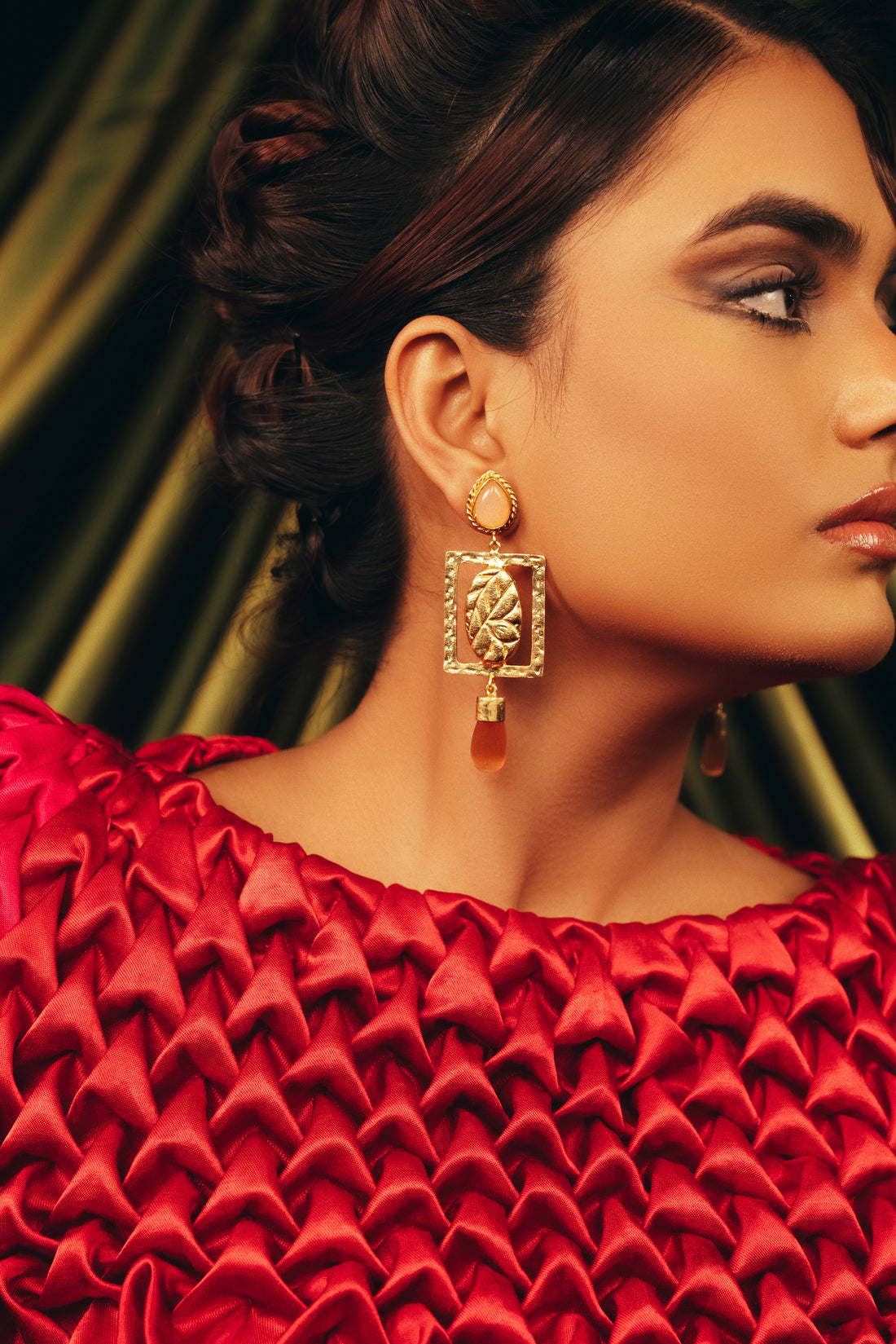 Handcrafted organic leaf drop earrings with natural gemstones styled on a model.