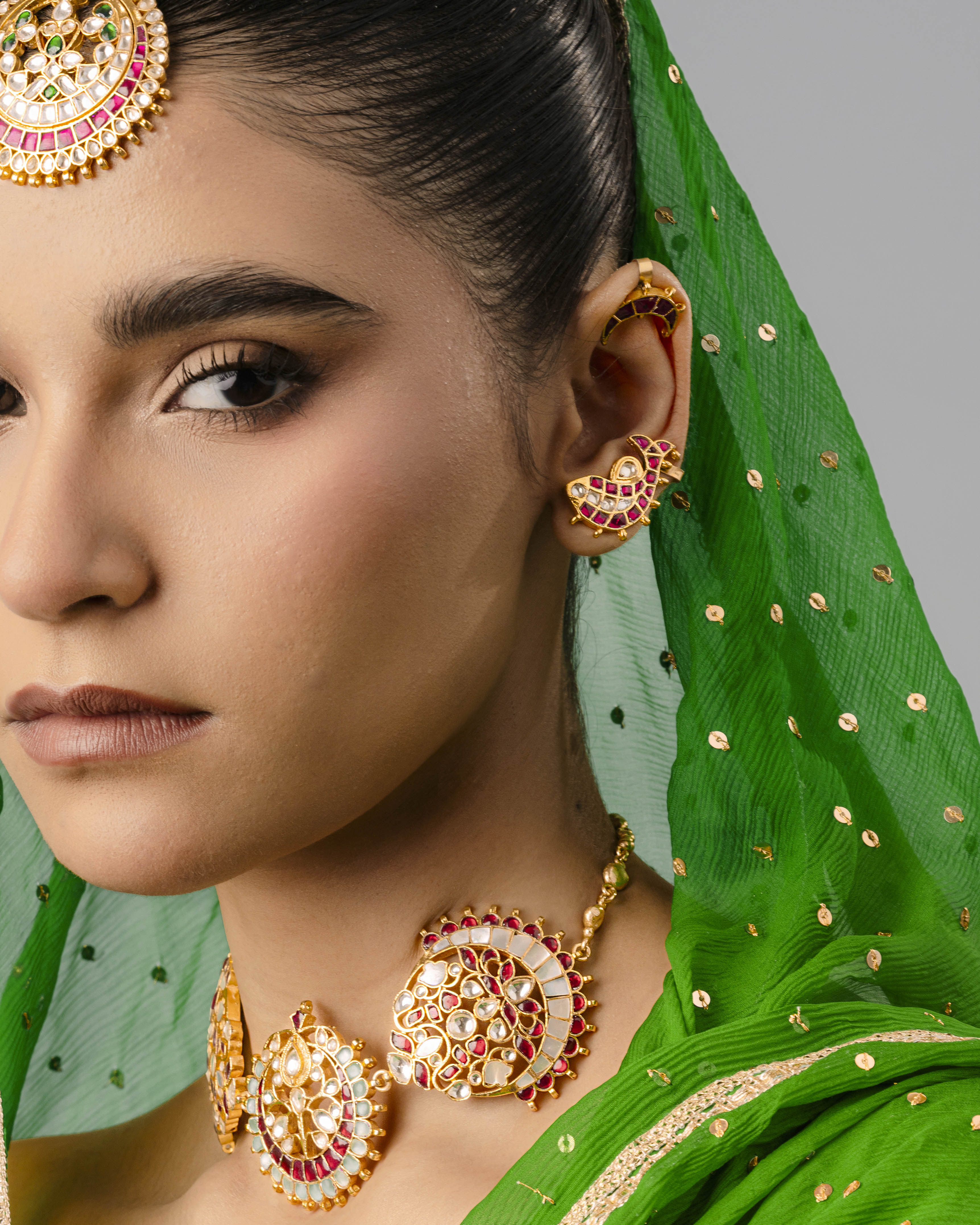 A premium brass fish ear cuff with detailed craftsmanship hugging the ear cartilage, styled for a modern festive look.