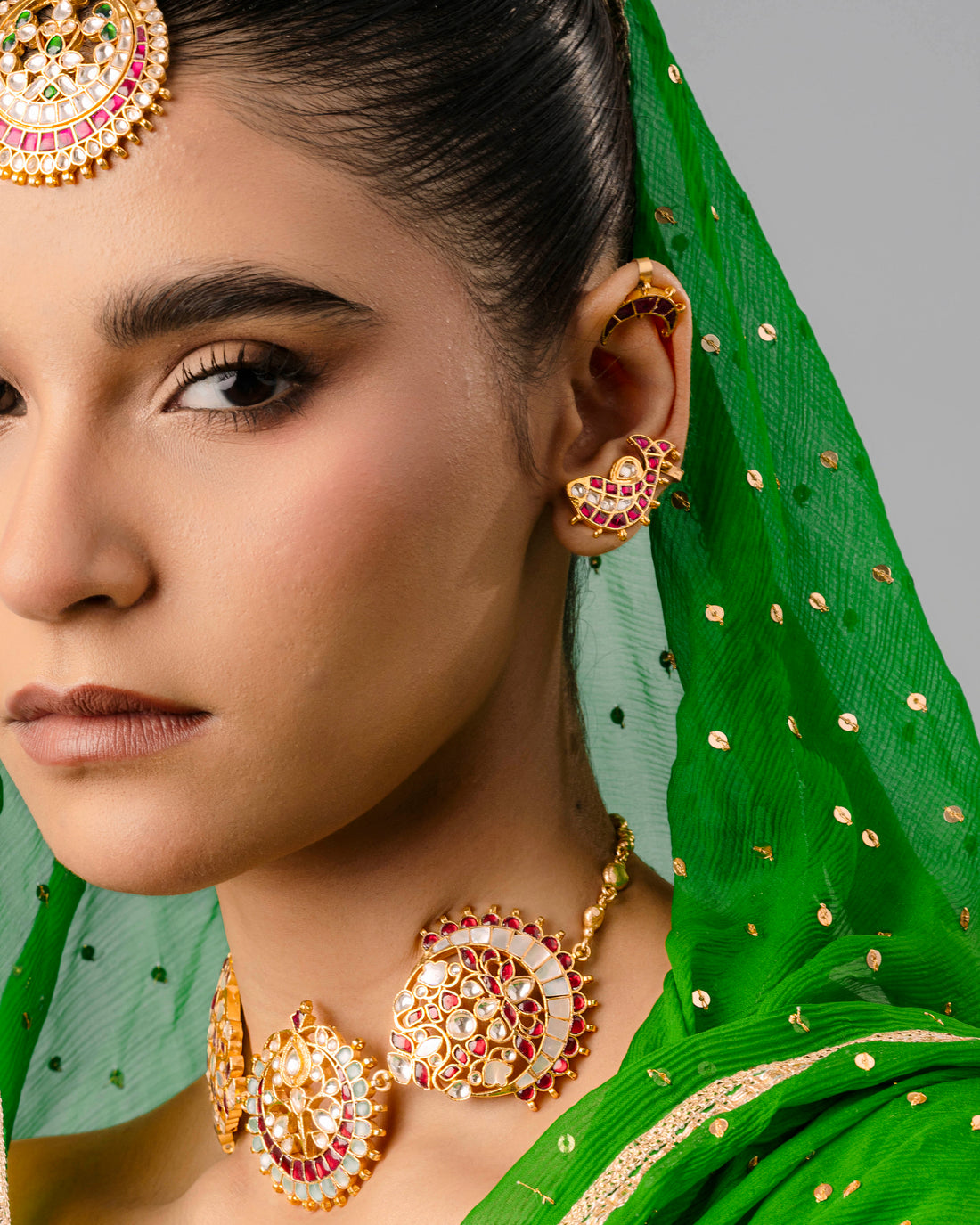 A premium brass fish ear cuff with detailed craftsmanship hugging the ear cartilage, styled for a modern festive look.