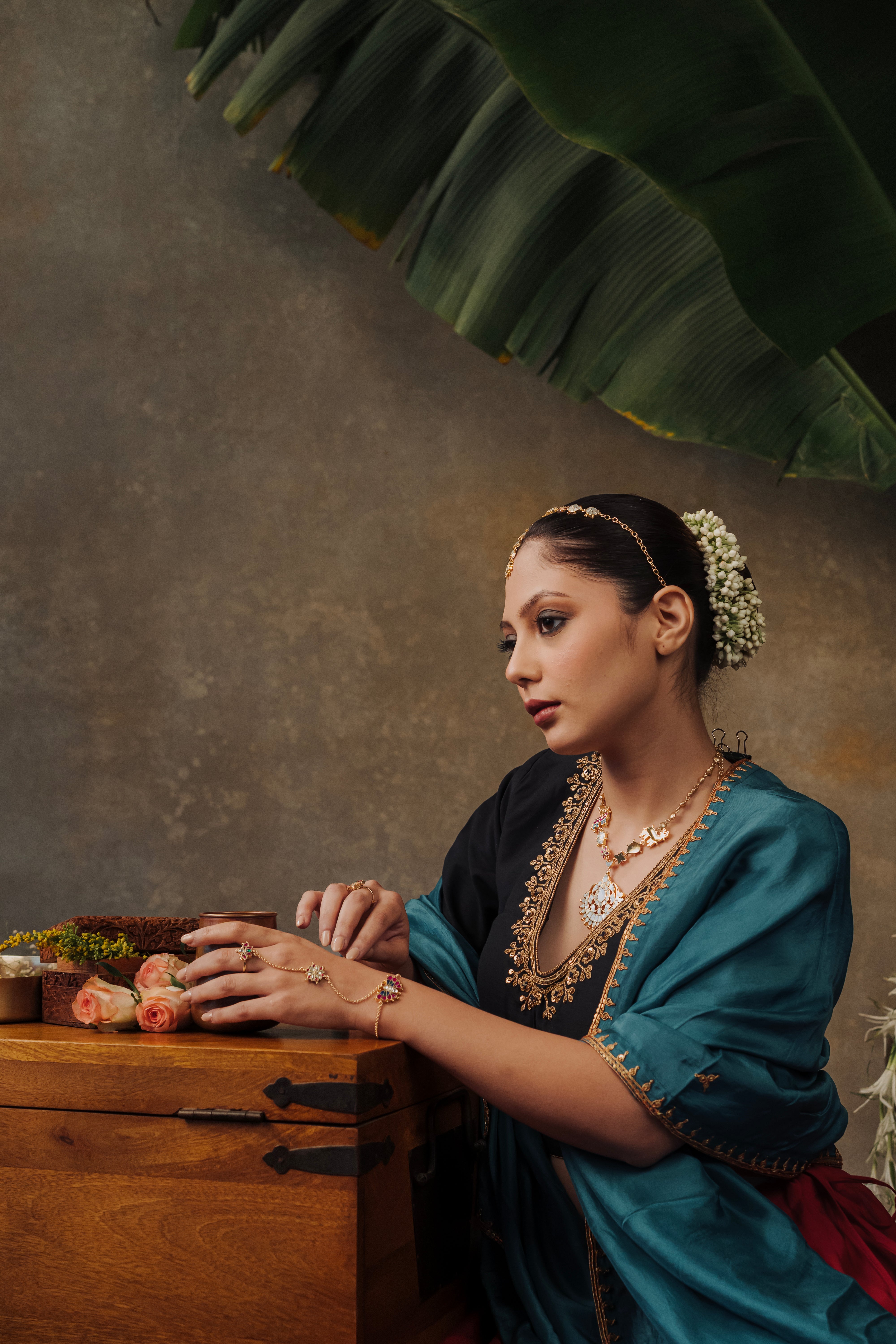 Model in traditional Indian bridal attire wearing a gold-plated Chand Mathapatti for wedding festivities