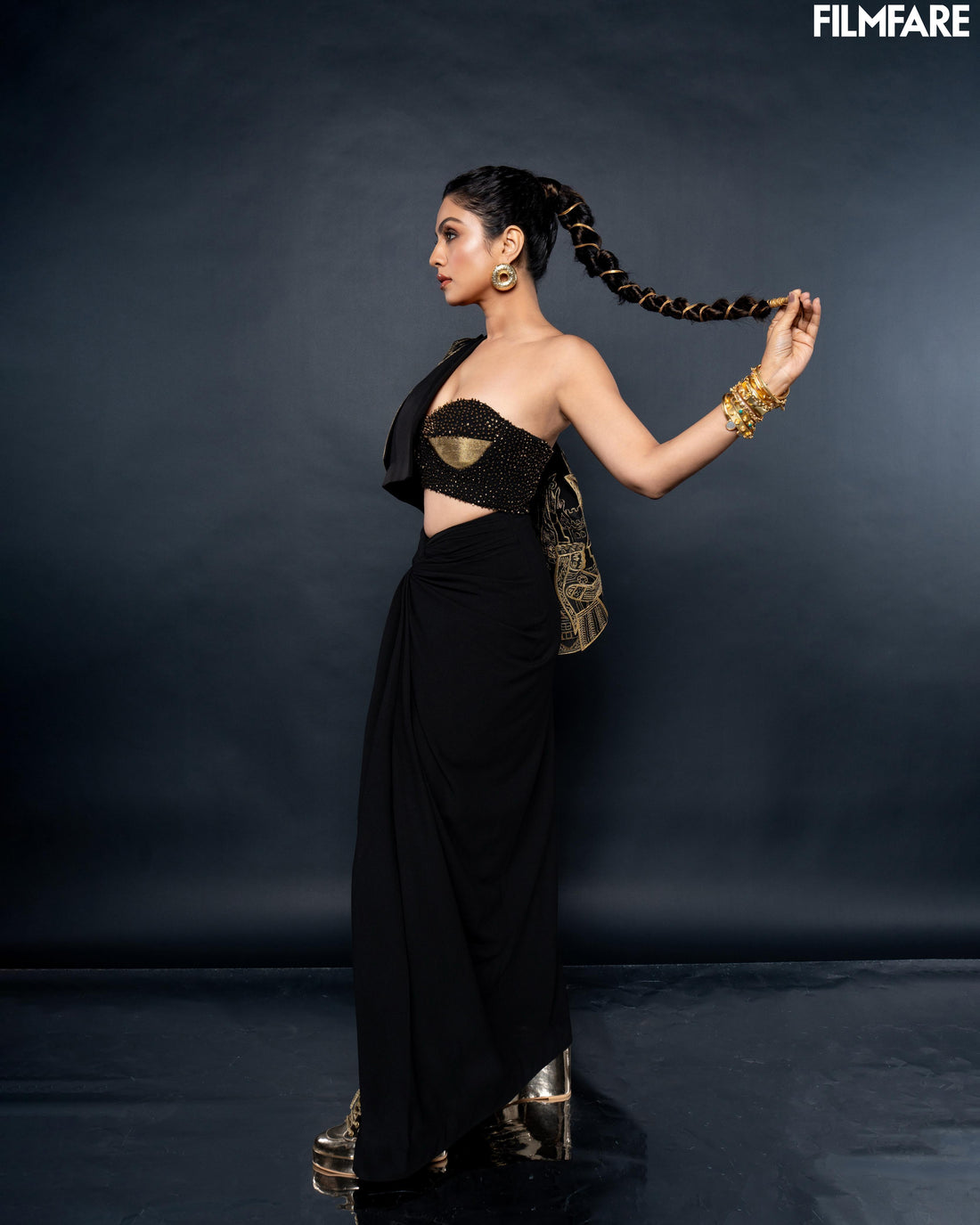 Woman wearing gold plated donut statement earrings styled with ethnic attire for wedding functions
