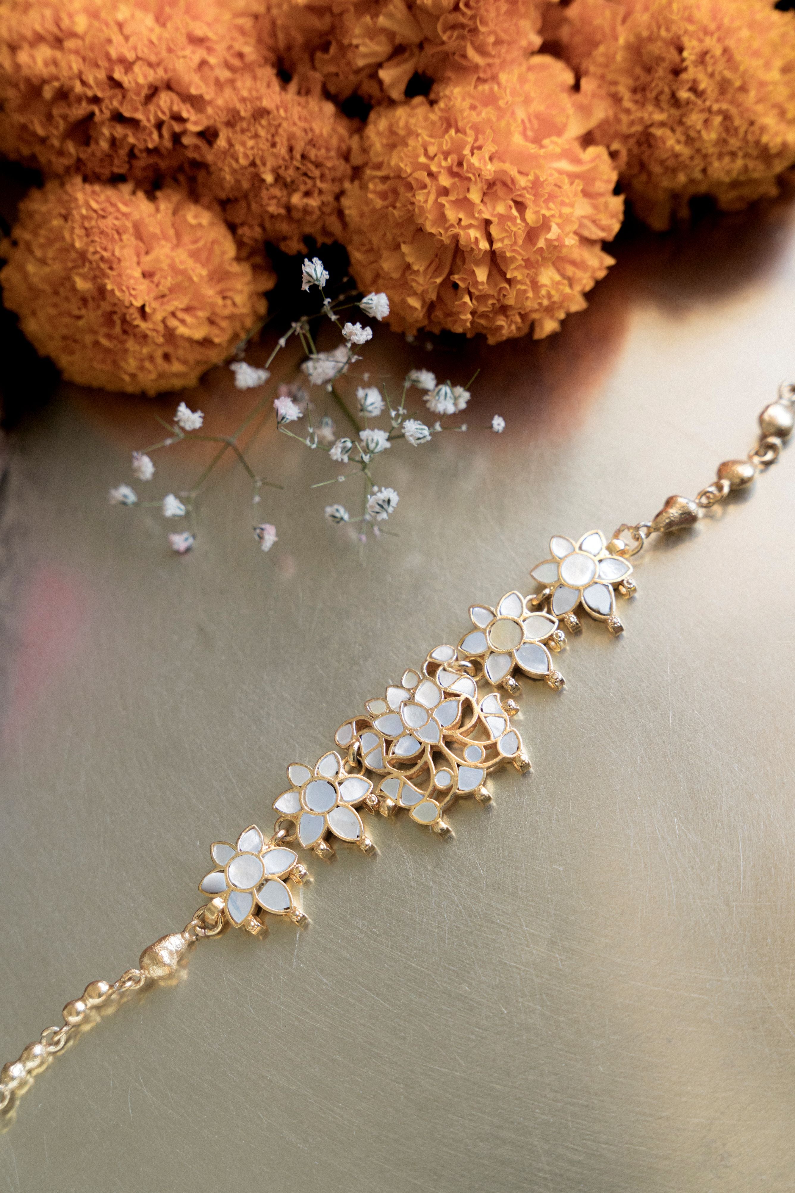 Handcrafted Indian ethnic mother of pearl flower choker necklace and earring set for weddings and festive wear.