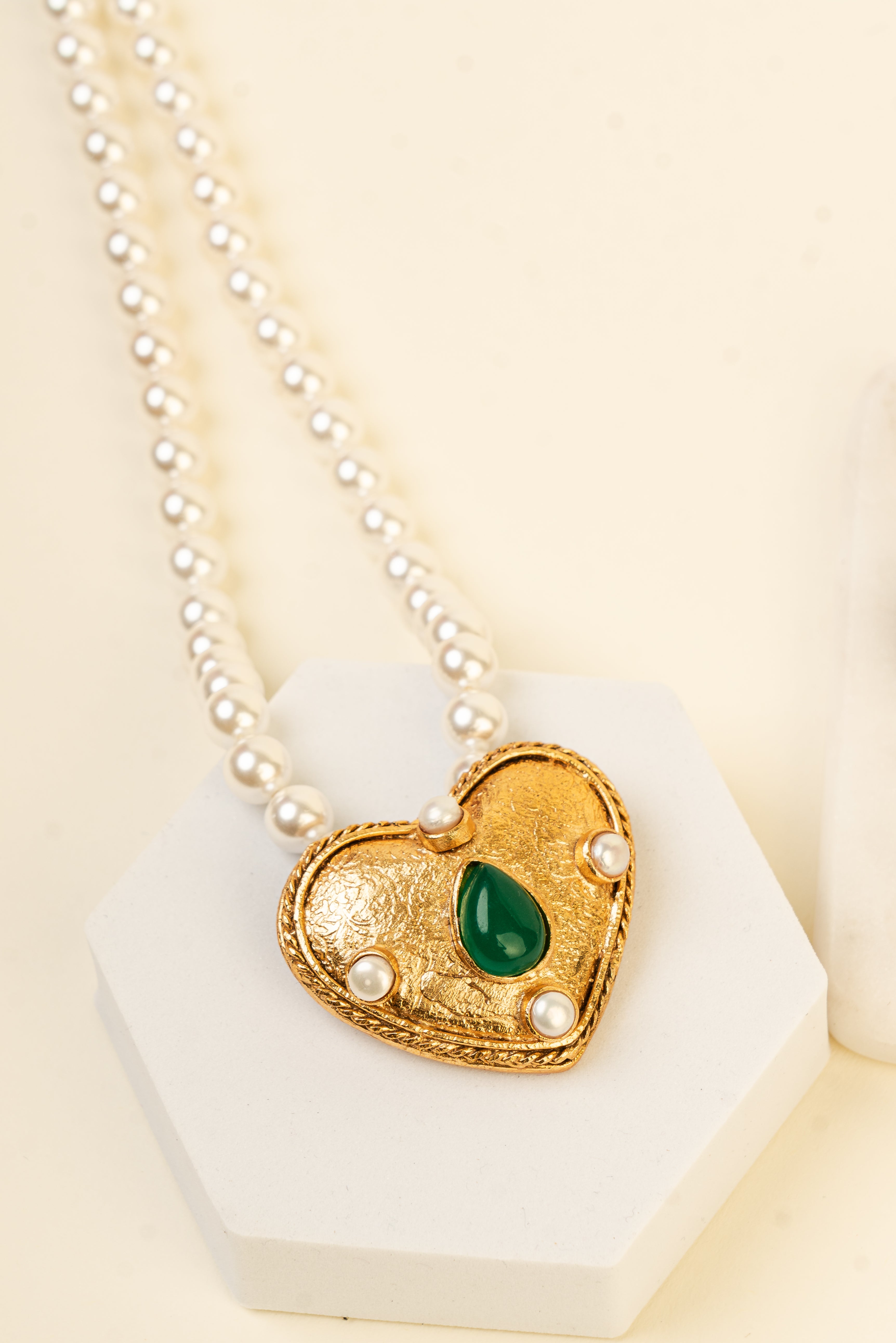 Baala Jewels gold heart-shaped pendant necklace with four lustrous pearls and a green teardrop stone.
