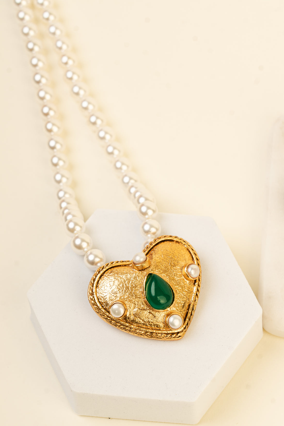 Baala Jewels gold heart-shaped pendant necklace with four lustrous pearls and a green teardrop stone.
