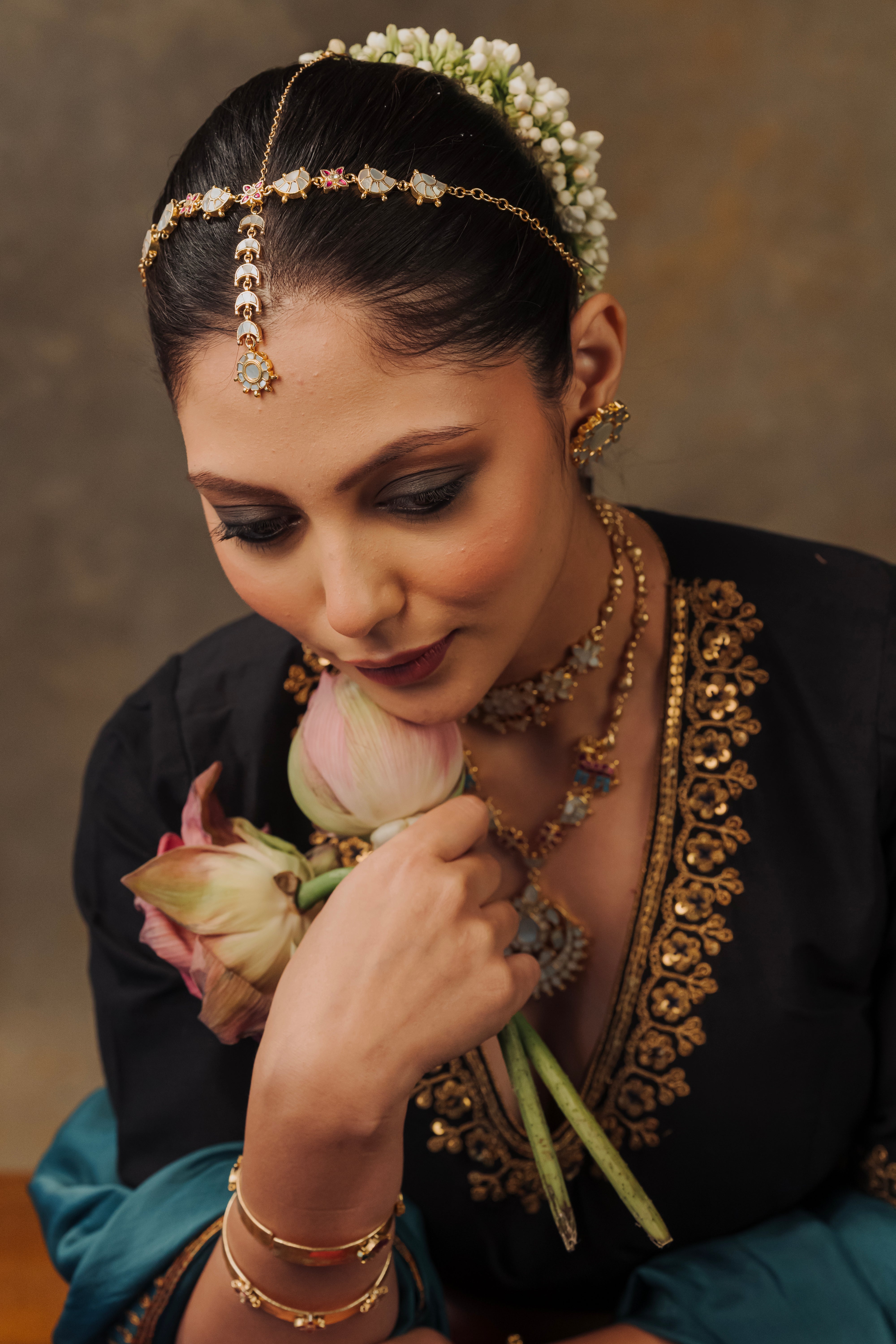 Woman wearing gold-plated Chand Mathapatti with mother-of-pearl inlay 