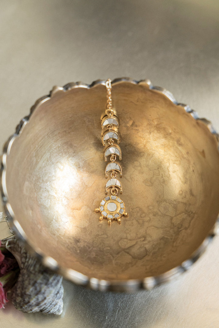 Gold-plated Chand Mathapatti with pink floral accents and mother-of-pearl half-moon layout