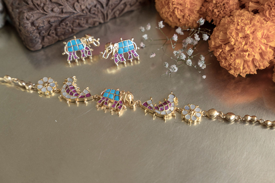 Gold-toned ethnic Haathi Kundan statement necklace with intricate enamel elephant charms and pearl chain styling.
