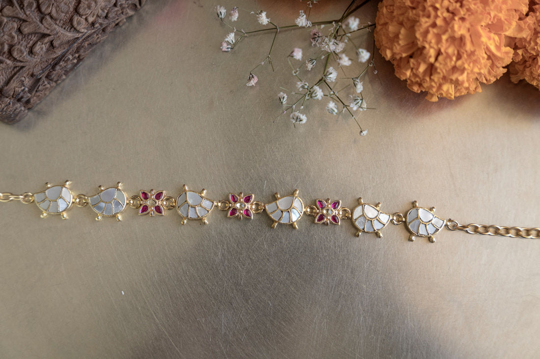 Handcrafted 18k gold-plated mathapatti featuring mother-of-pearl half-moon motifs and pink accents