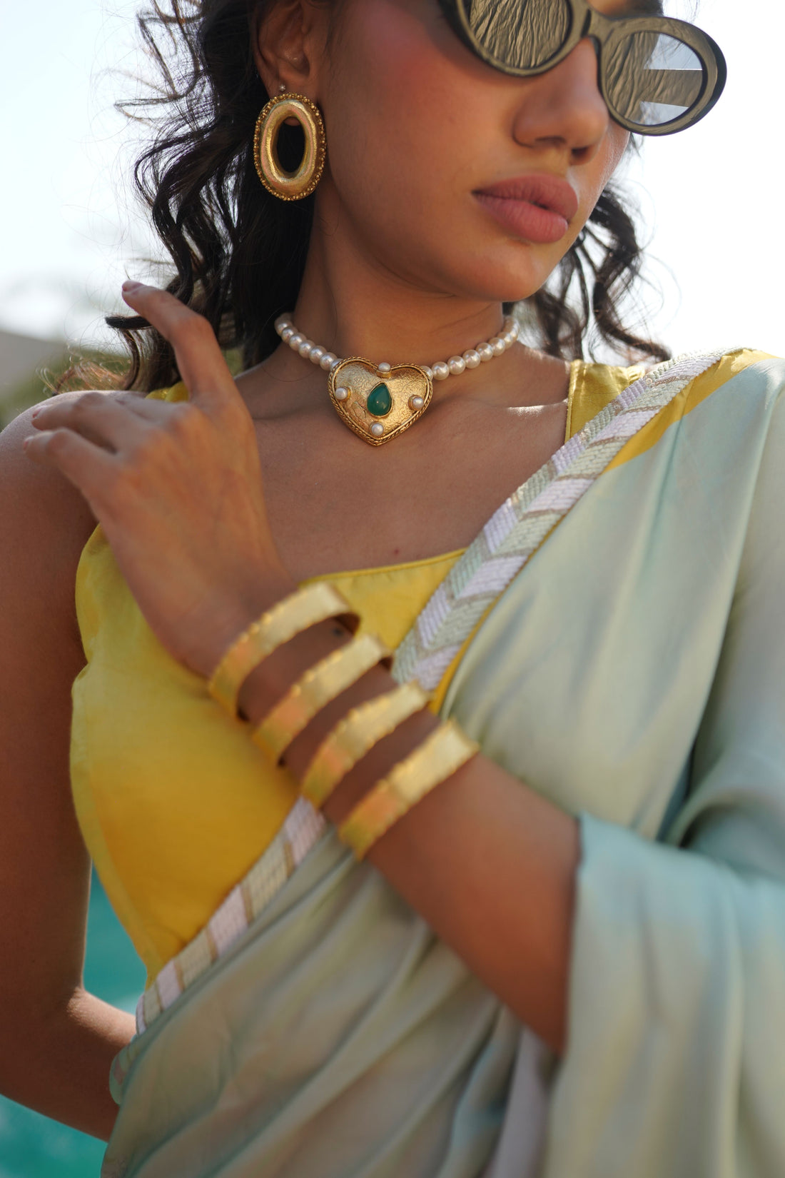 Ethically handmade 18k gold-plated heart necklace with green teardrop stone and pearl embellishments.