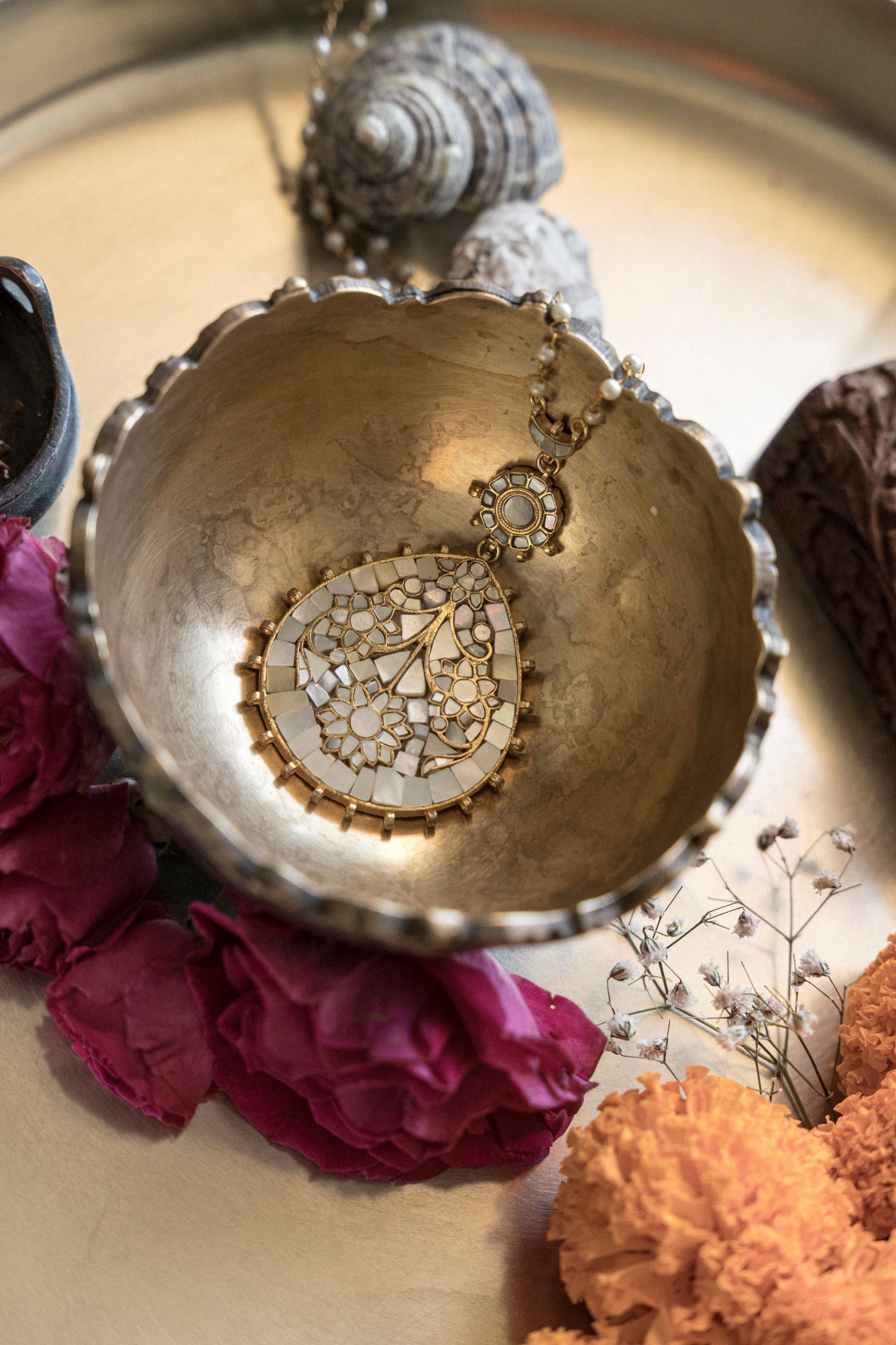 Handcrafted gold plated long pendant necklace featuring a mother of pearl stone and intricate leaf motifs