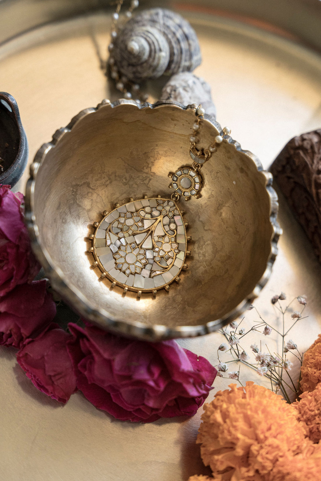 Handcrafted gold plated long pendant necklace featuring a mother of pearl stone and intricate leaf motifs