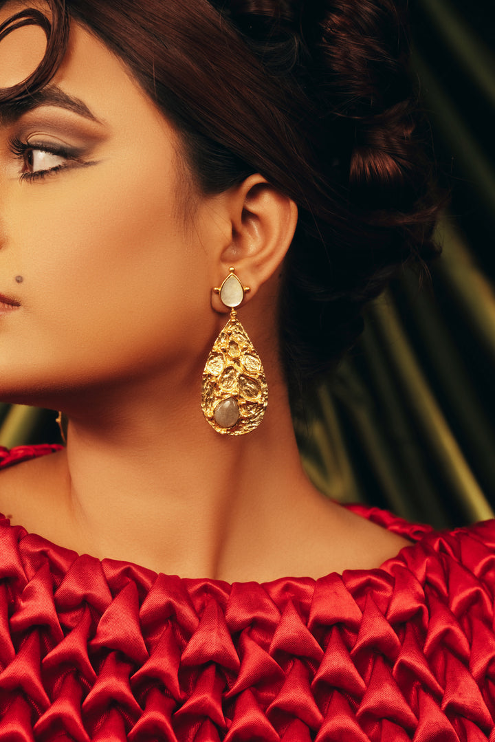 Gold chandelier statement drop earrings worn with red party outfit