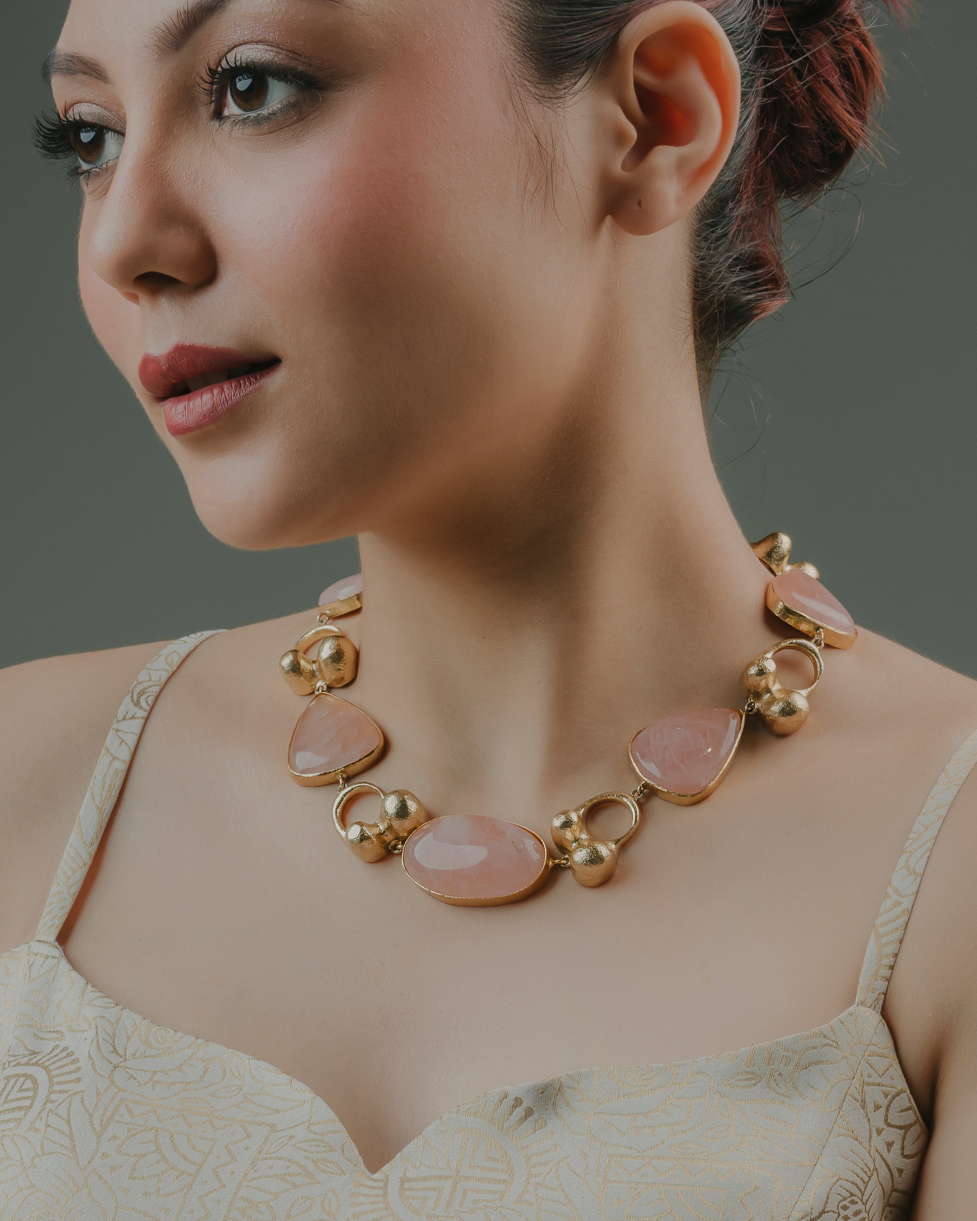 Handcrafted modern Indian gold-toned necklace studded with oval rose quartz stones