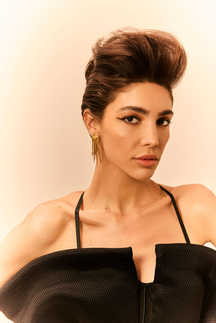 hand-set gold bezel drop earrings with a black top.