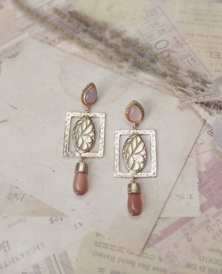 Gold leaf dangle earrings with ruby zoisite drop stones for party wear and special occasions.