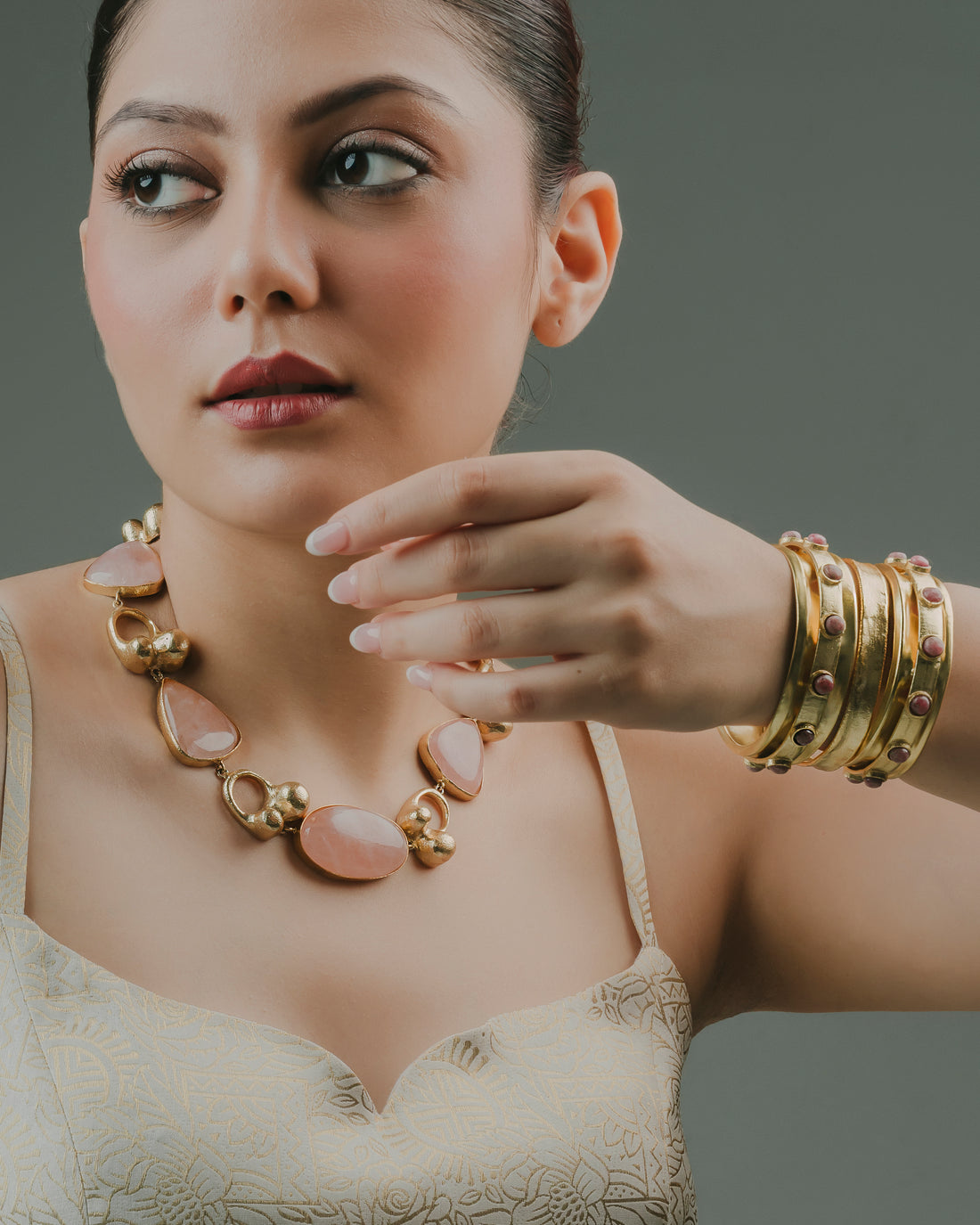 baala jewels woman wearing a rose quartz gold-plated statement necklace