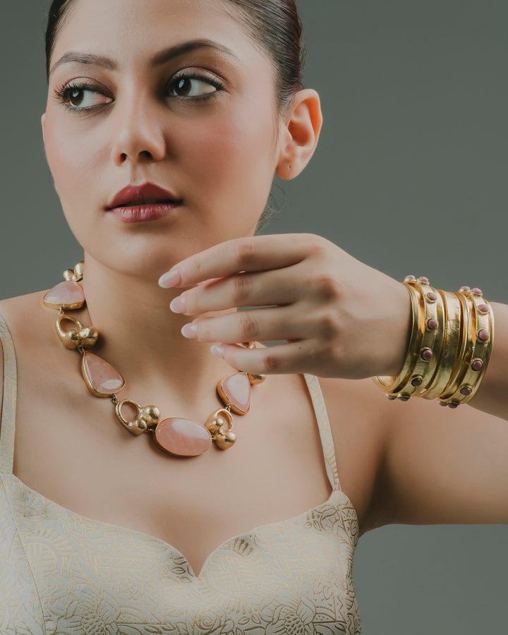 baala jewels woman wearing a rose quartz gold-plated statement necklace