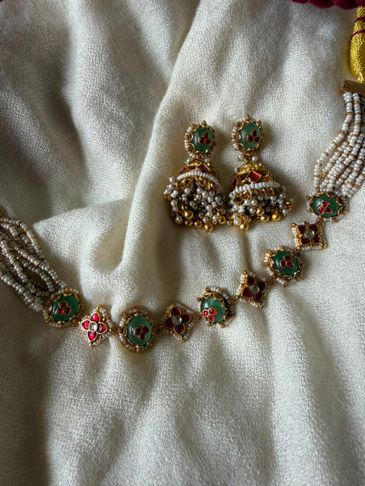 Handcrafted gold-plated Kundan choker necklace with green and red Meenakari enamel details and matching Jhumka earrings