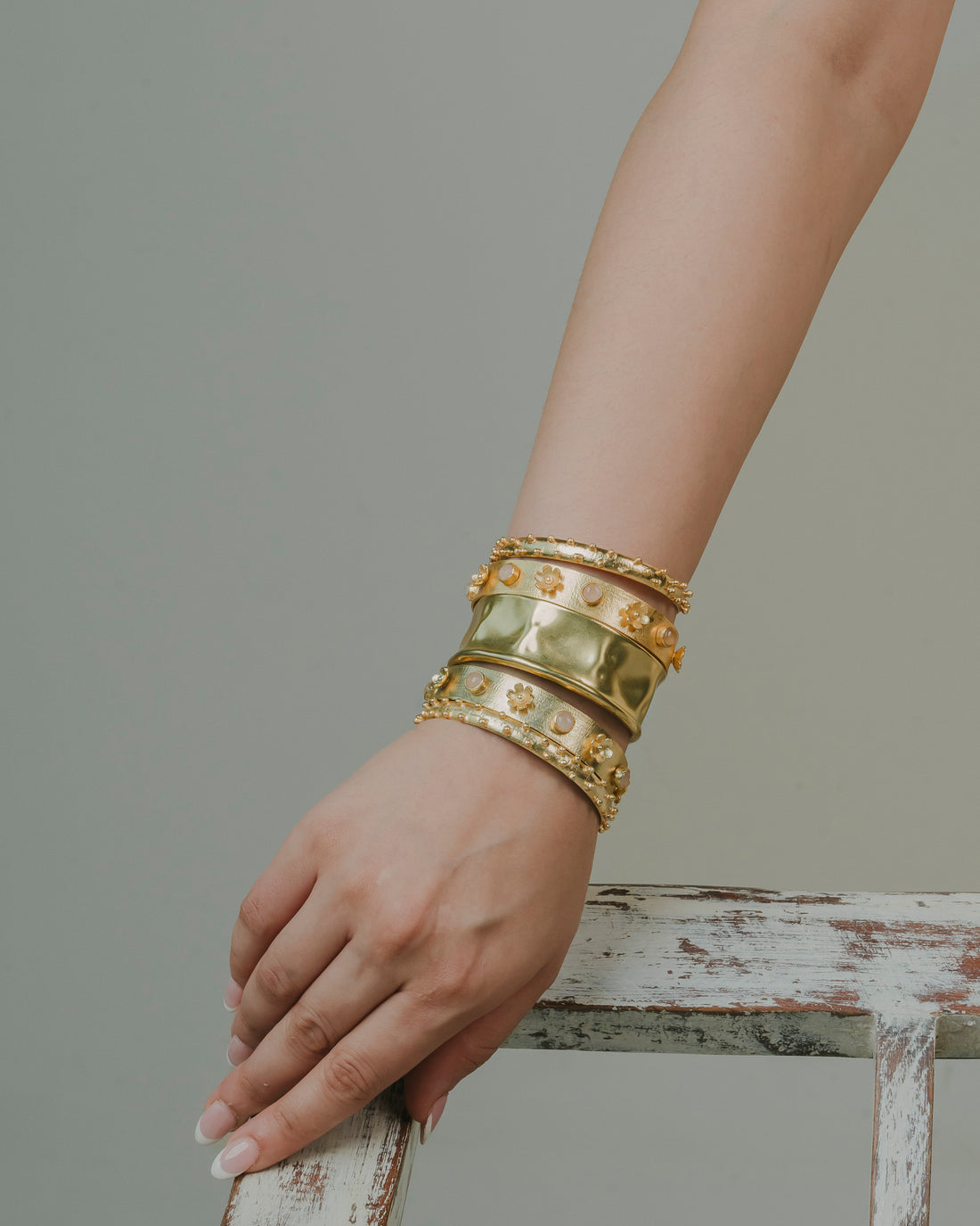 a stack of bold 18k gold-plated chunky bracelets with light pink stone. edgy, beautiful and best for ethenic and bold partywear look.