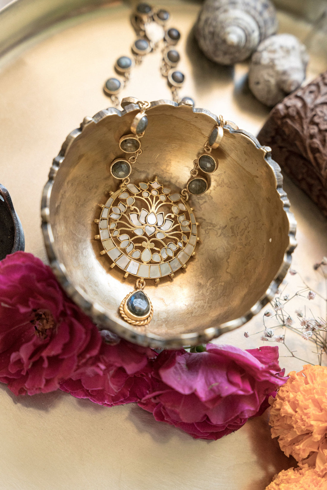 Woman in traditional saree wearing a handcrafted temple jewelry necklace with black onyx teardrop pendant