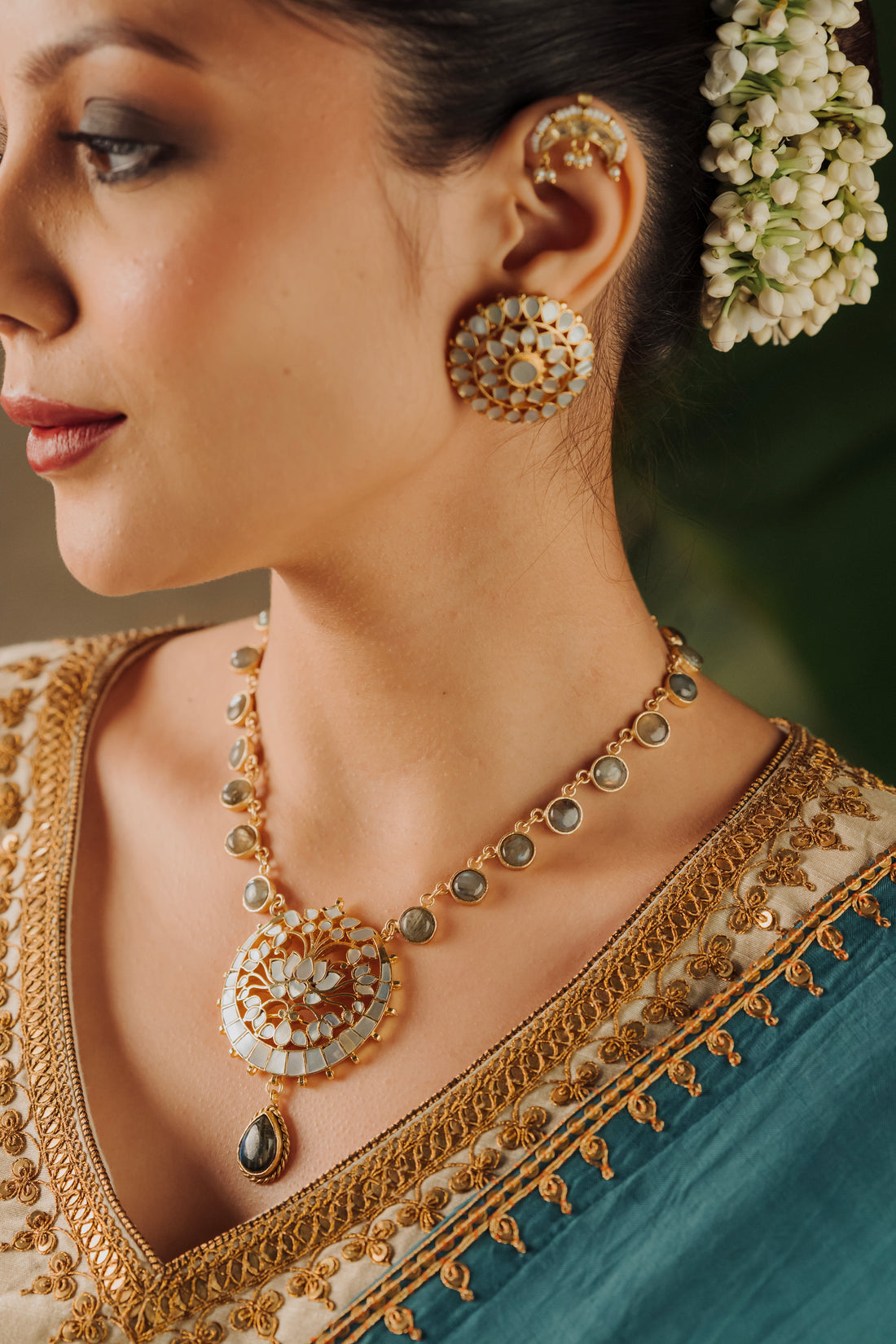 handcrafted gold-toned statement necklace with a circular lotus pendant and matching ear cuffs