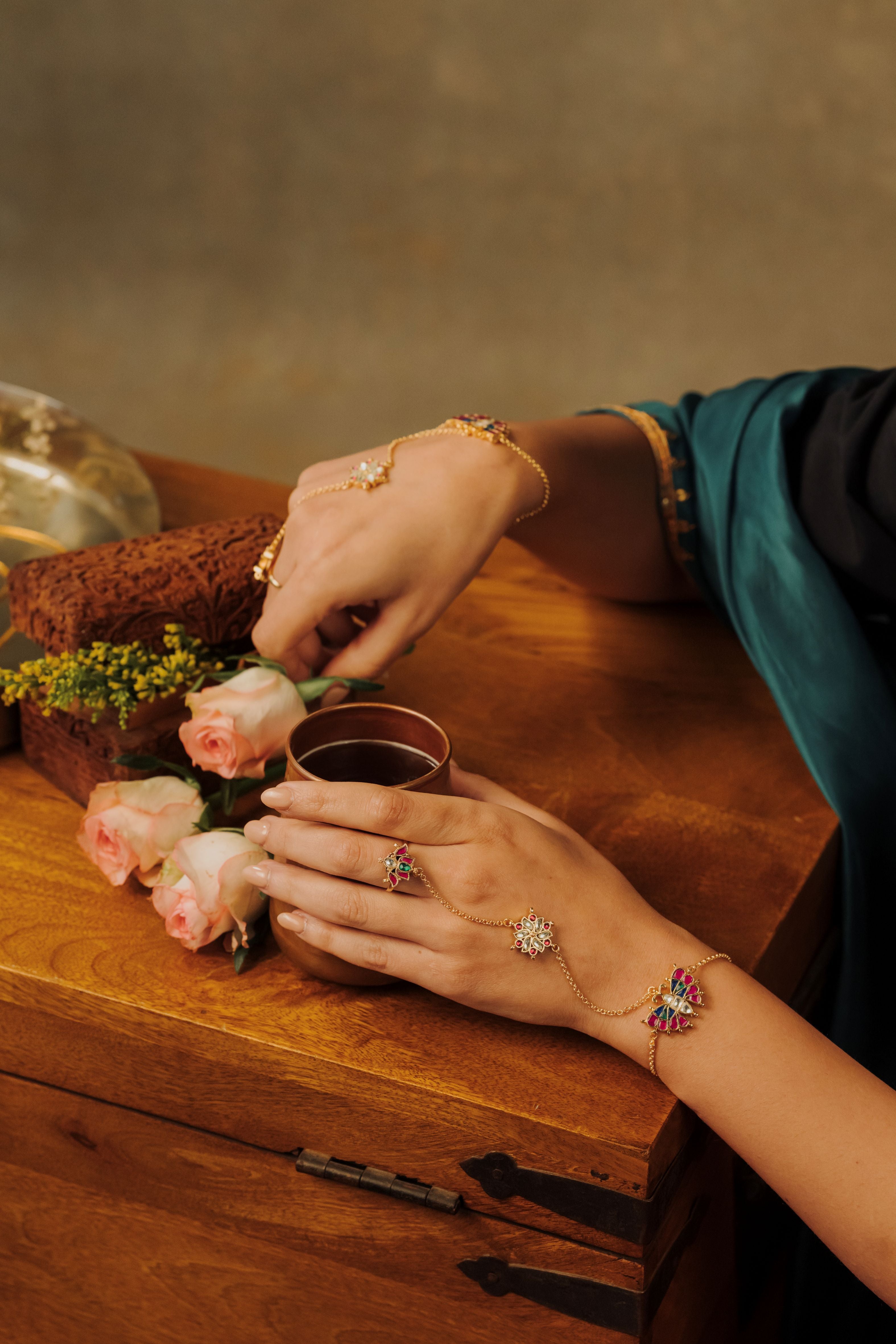 A gold-plated butterfly hathphool bracelet is worn with traditional Indian ethnic attire.