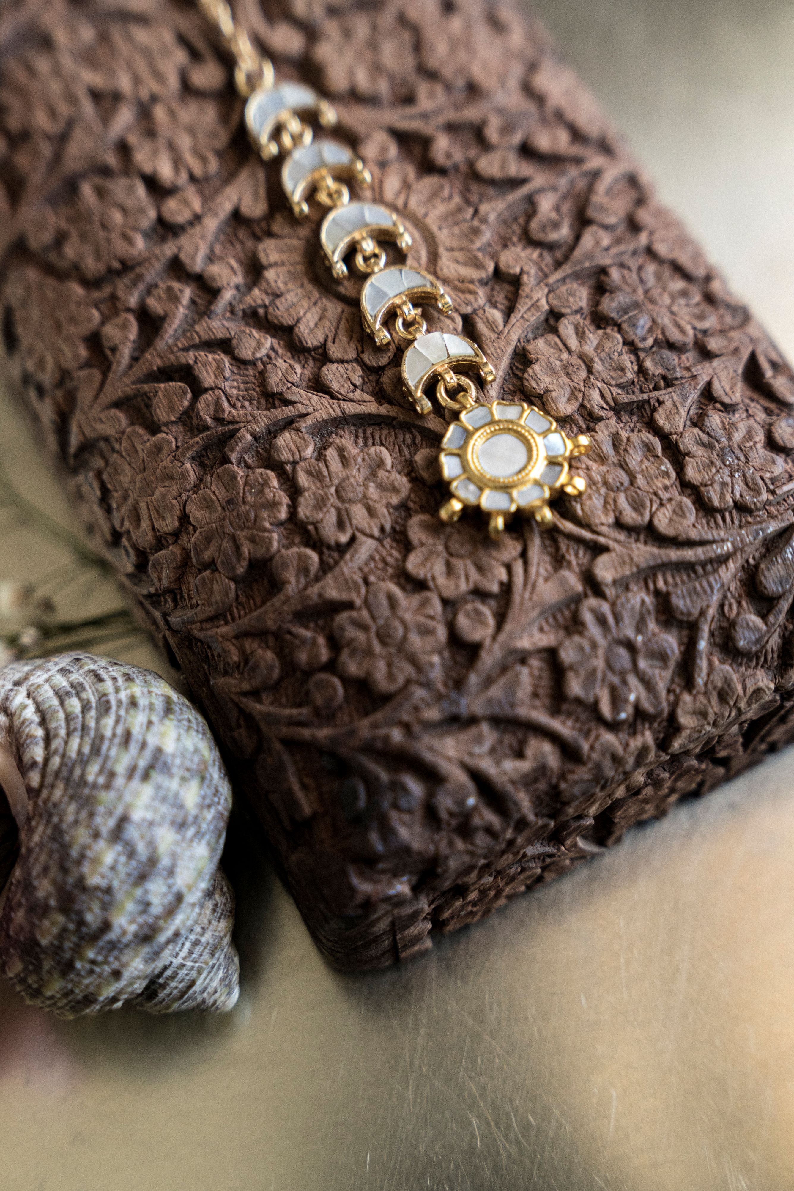 traditional gold Chand Mathapatti headpiece styled with a gajra hair bun