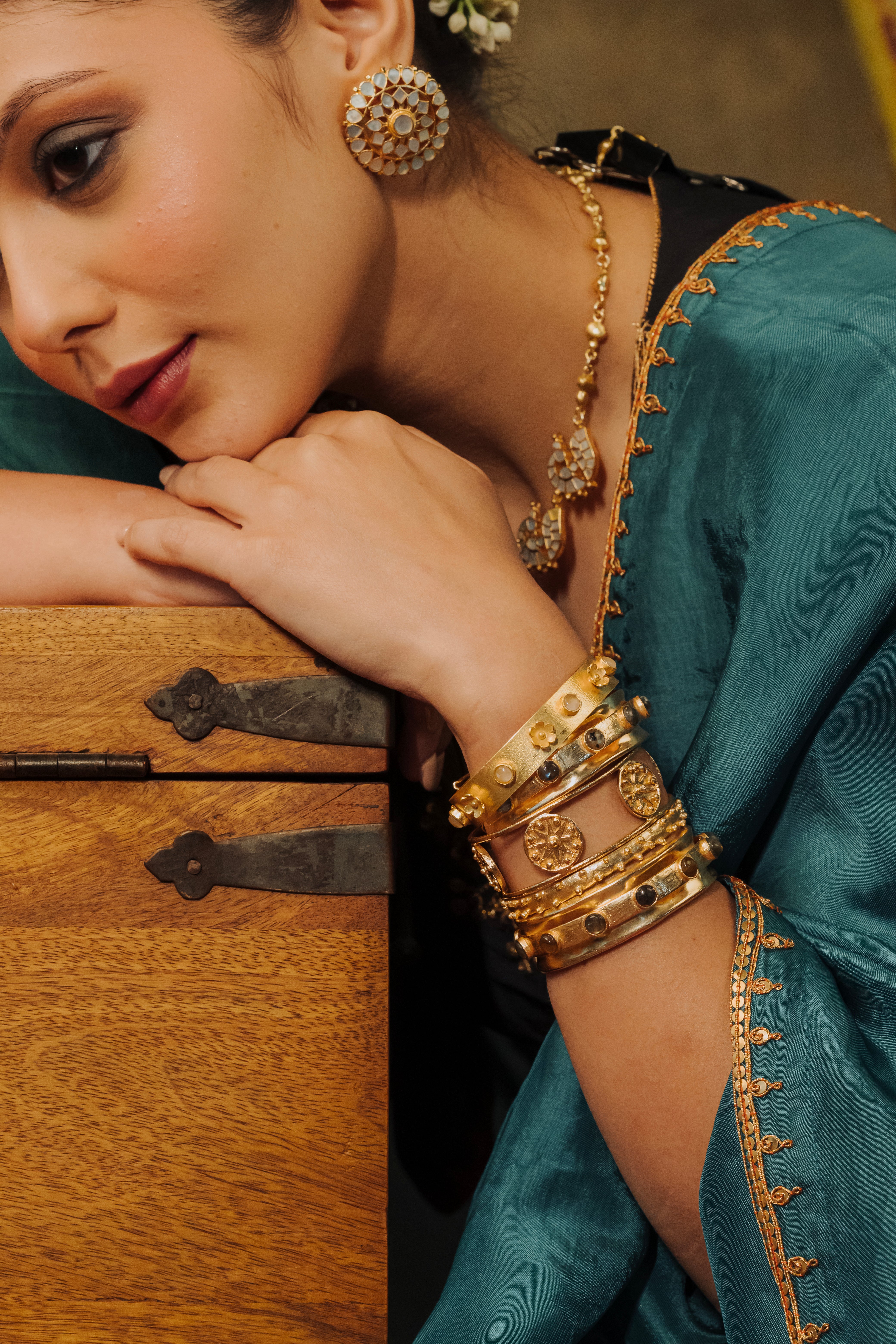 Close-up of traditional Indian gold plated bangle stack styled with ethnic attire