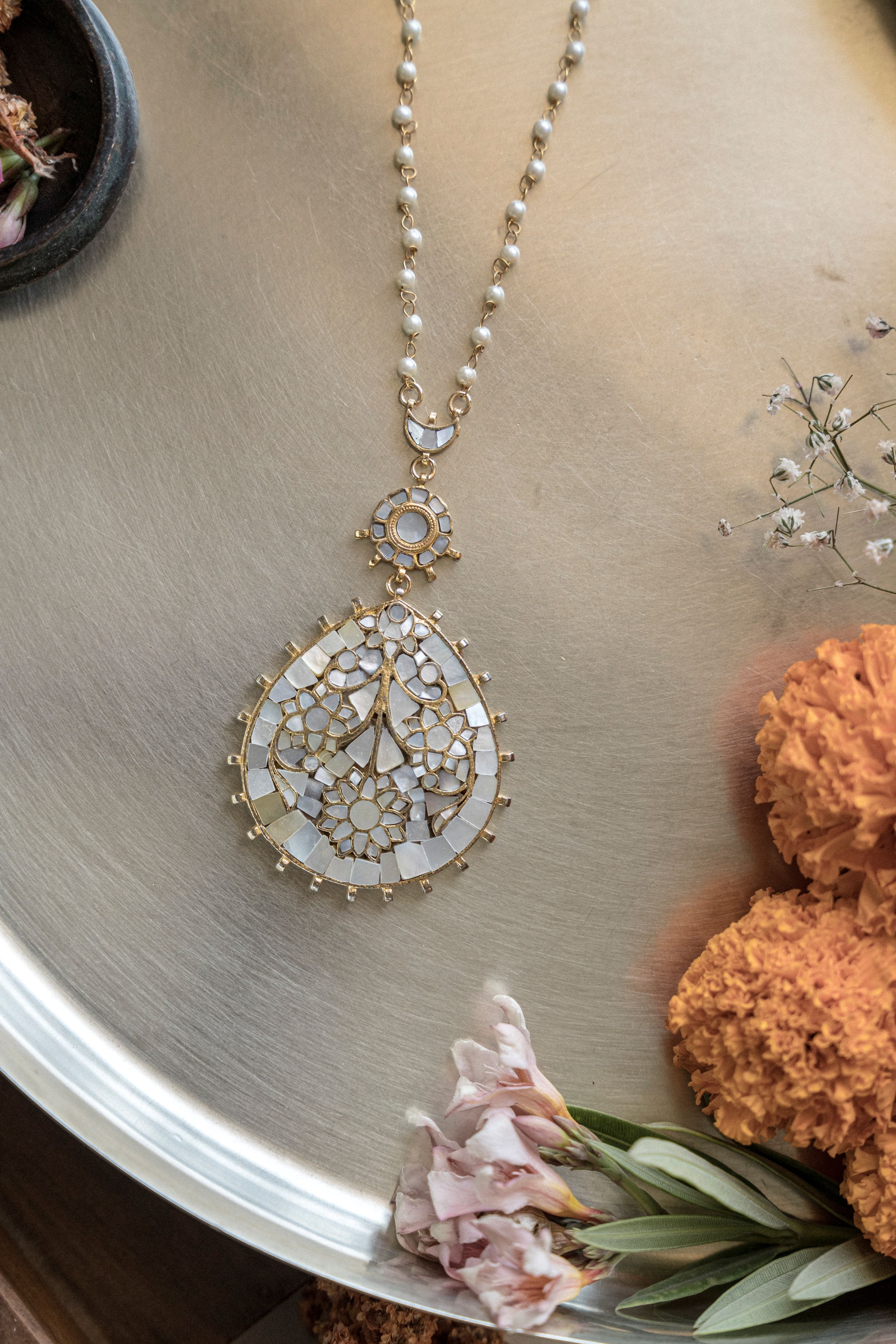 gold-plate mother-of-pearl pendant necklace paired with heavy gold sequin outfit