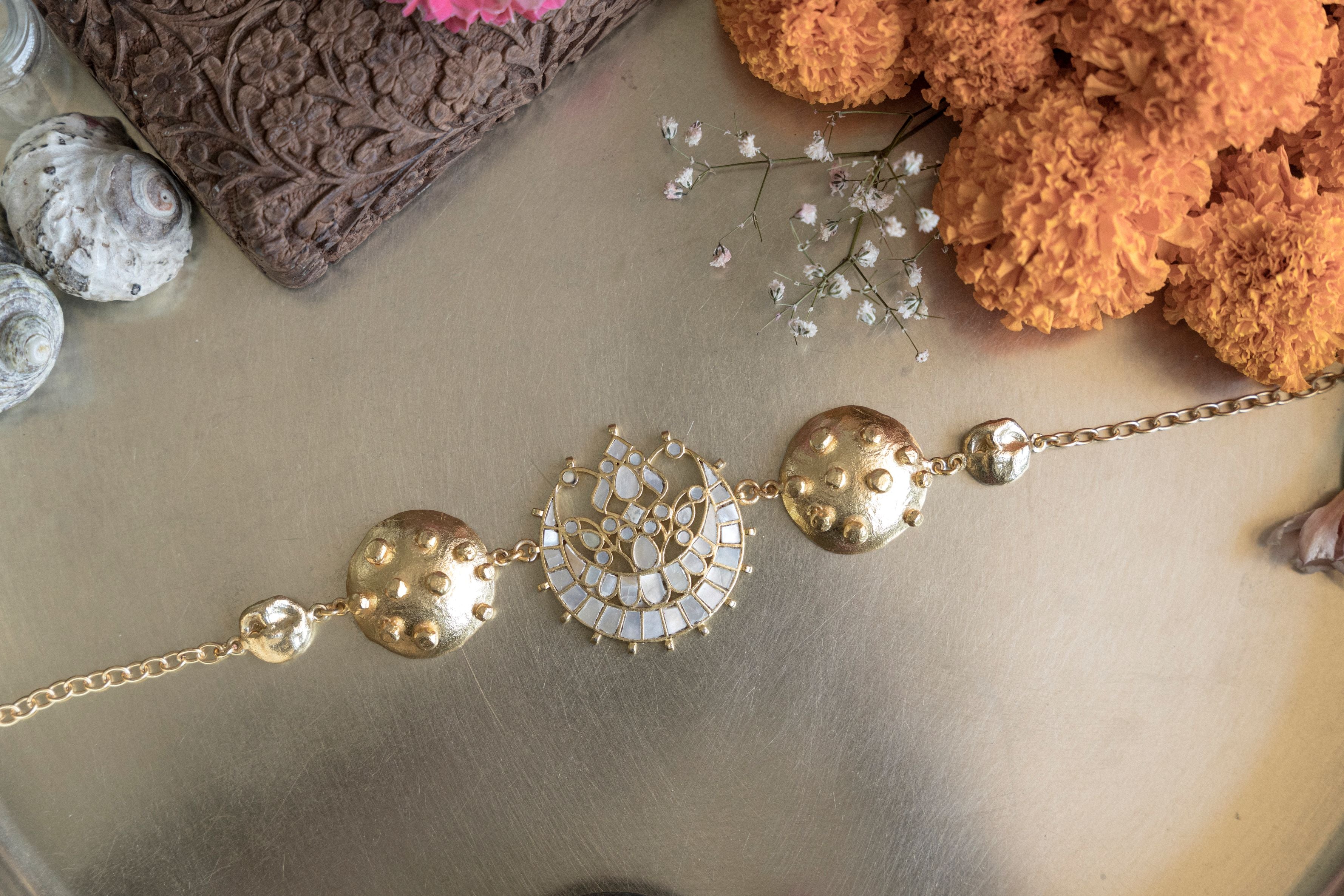 Gold plated choker necklace featuring a mother-of-pearl crescent moon pendant 