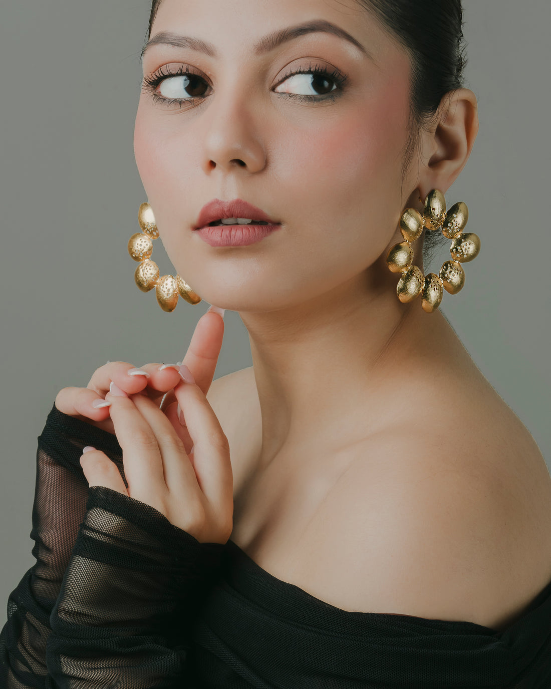 gold-toned leafy floral hoop earrings for party wear.