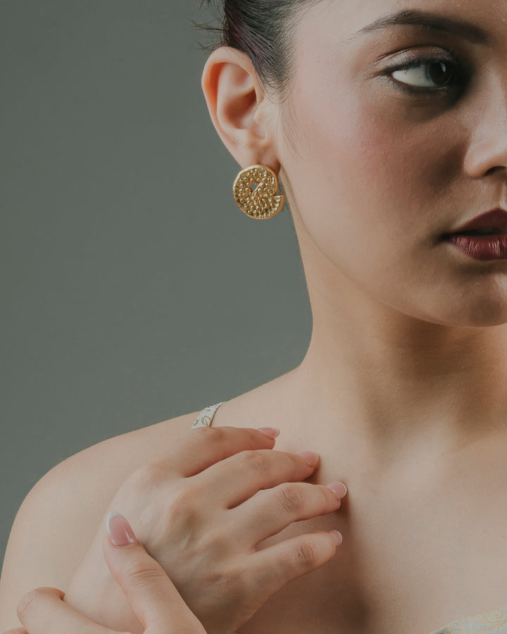 handcrafted gold-plated Coma Stud earrings with a textured geometric pattern.