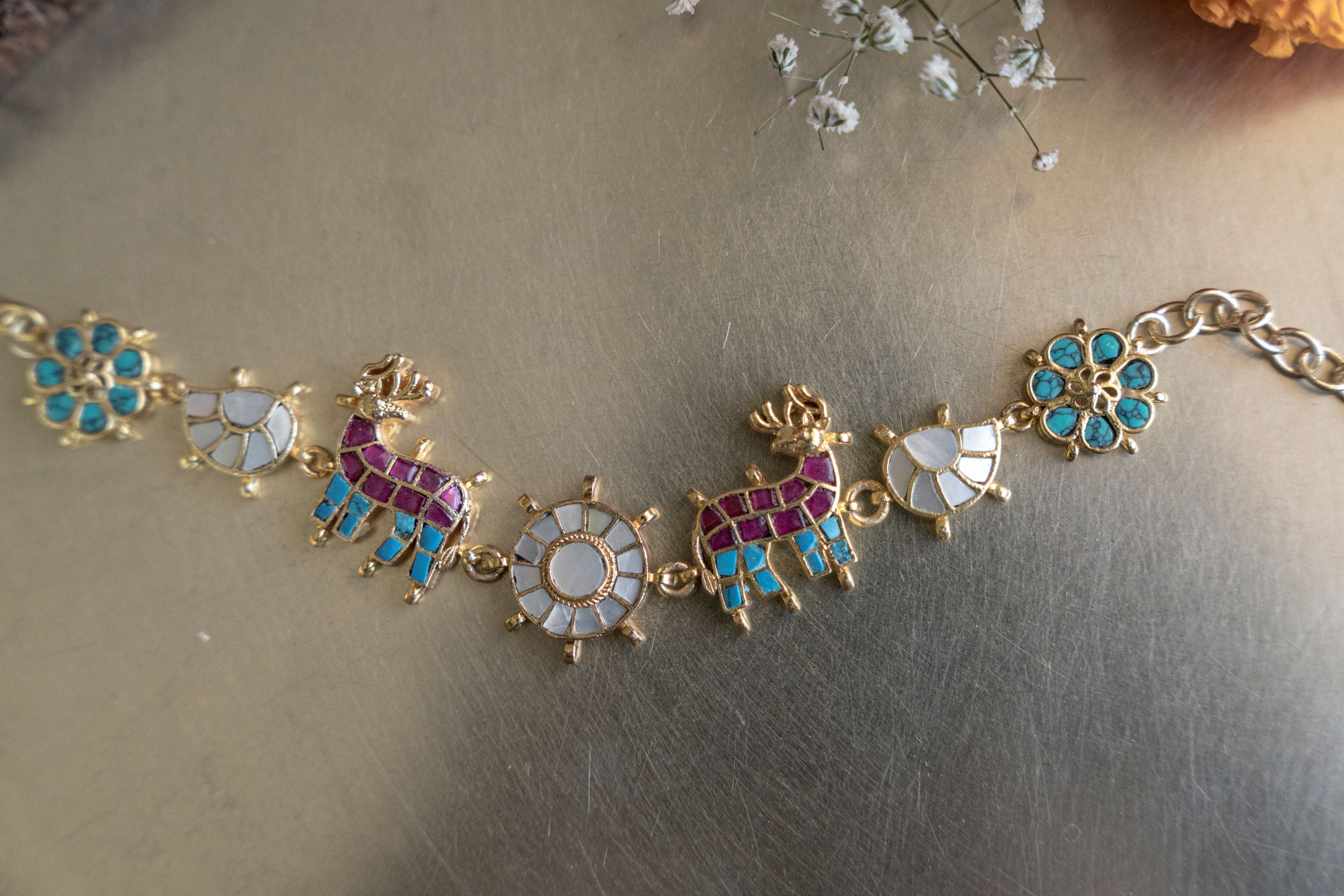 Gold-plated choker necklace set featuring red and blue stone deer motifs with mother-of-pearl accents