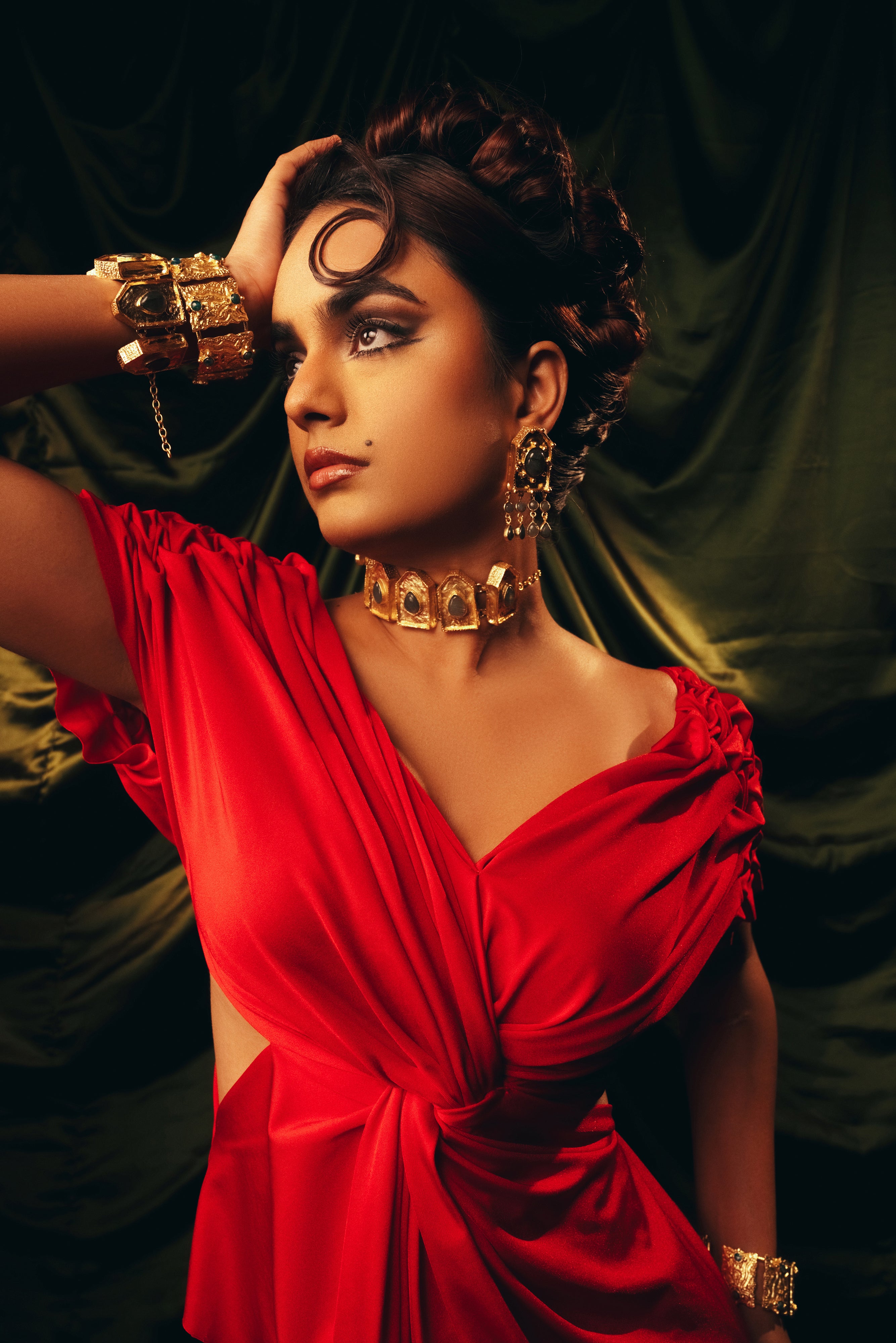Model wearing the BaalaJewels Ebon Eclat gold choker necklace styled with matching gold statement earrings