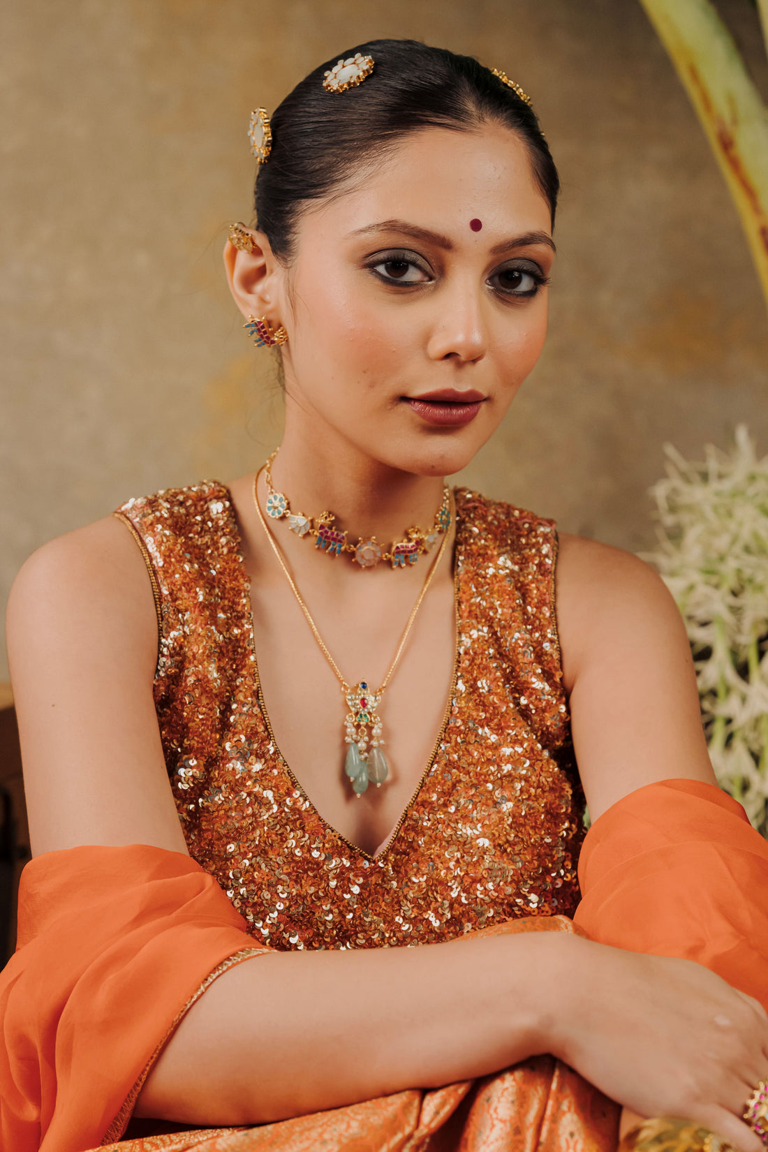 Woman styling a traditional gold-plated Jadau Kundan necklace set for bridal and wedding functions.