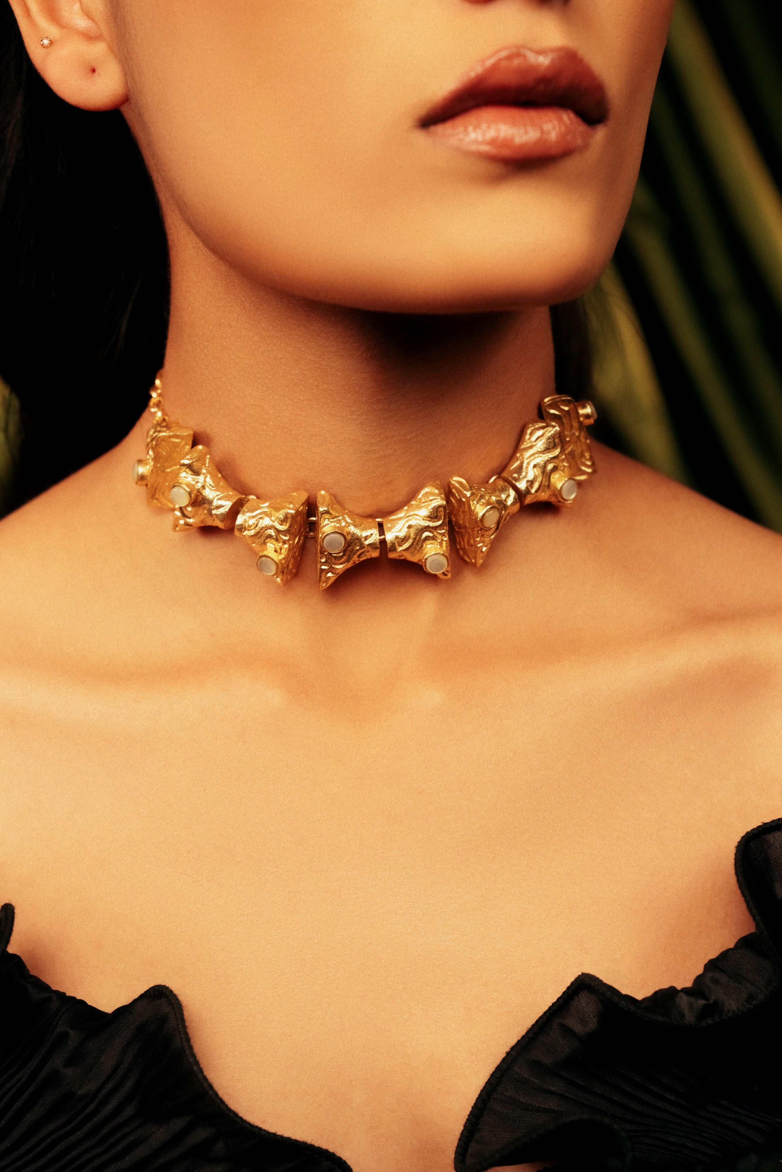 Lattice Luxe gold statement choker necklace featured on model with black ruffled dress