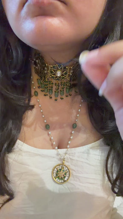 Handcrafted gold-toned Kundan choker featuring intricate meenakari detail work and cascading green bead drops