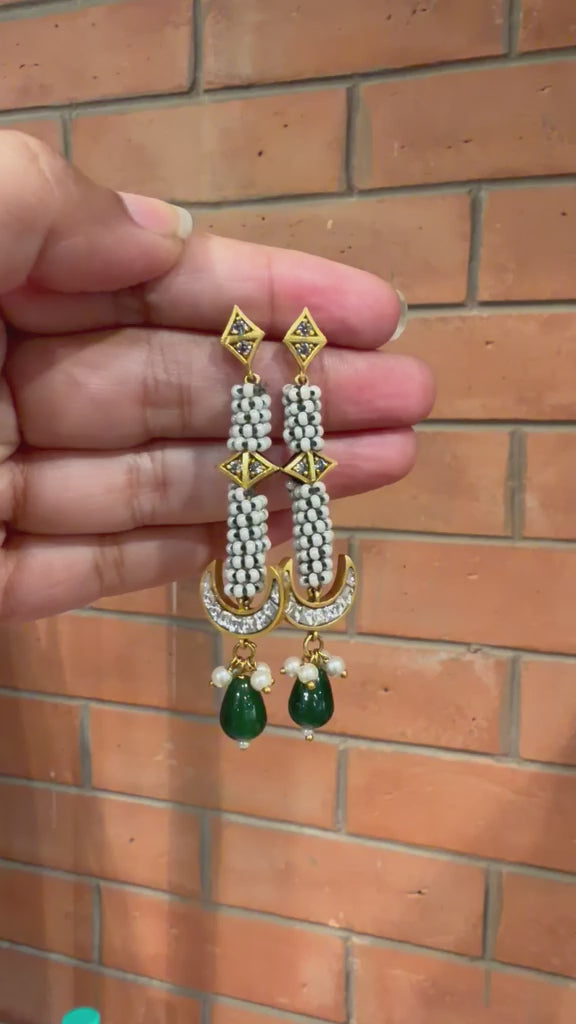 Handcrafted traditional Indian Moti Kundan statement earrings with pearl borders paired with white ethnic attire.