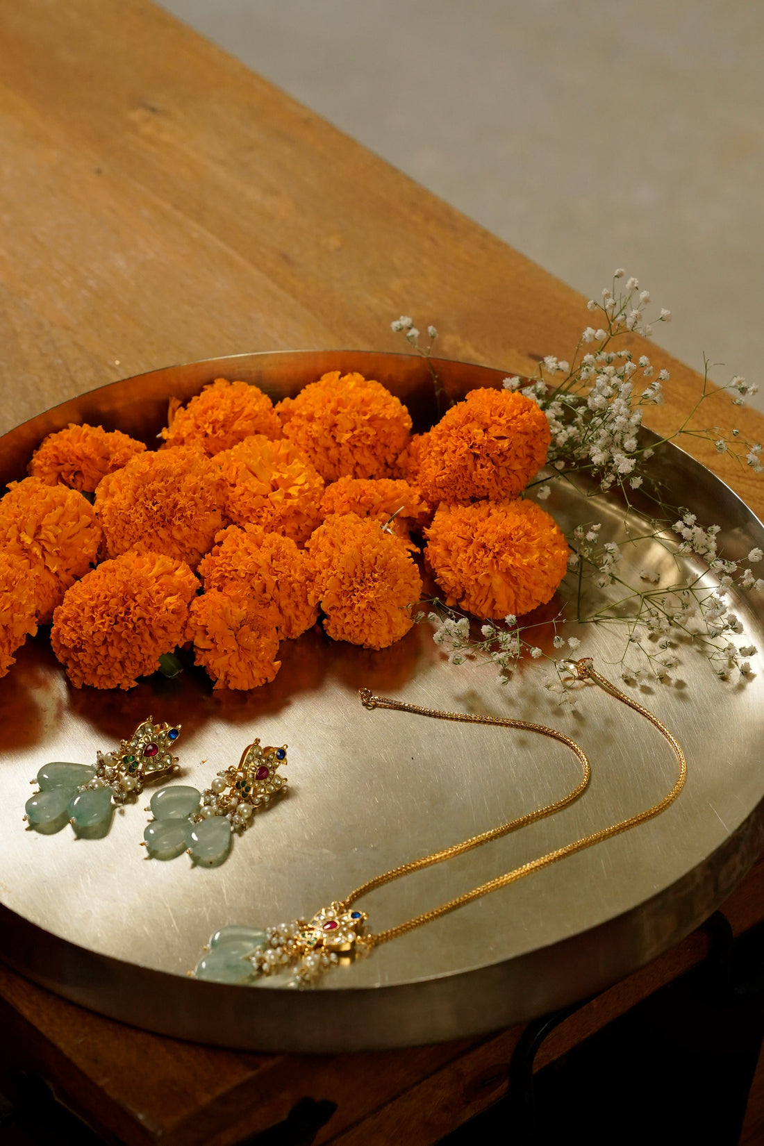 A traditional Indian wedding jewellery set featuring a gold-plated long pendant necklace and matching dual-layer earrings.