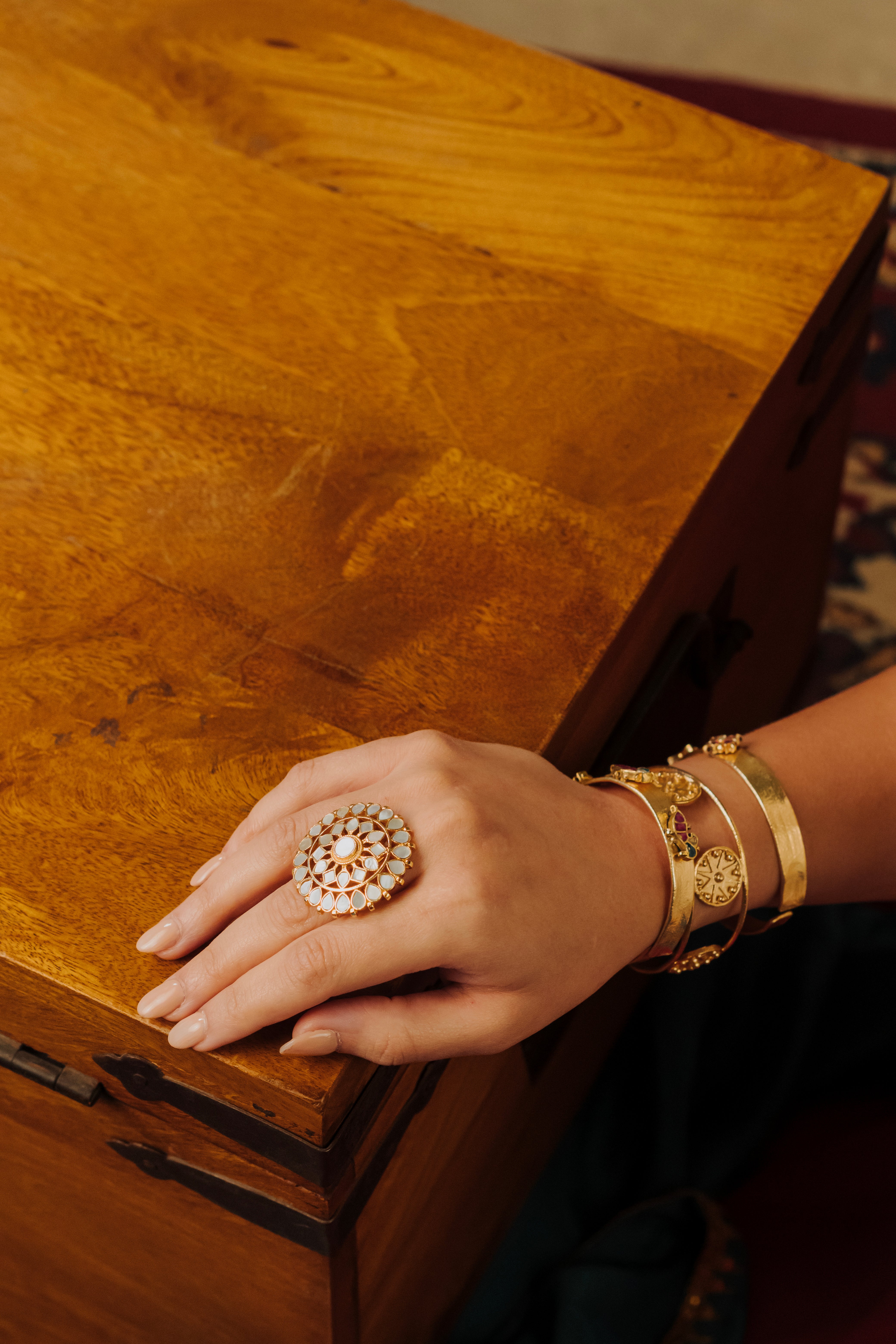Vintage-inspired fish and floral pattern gold stack bracelet with raised embellishments
